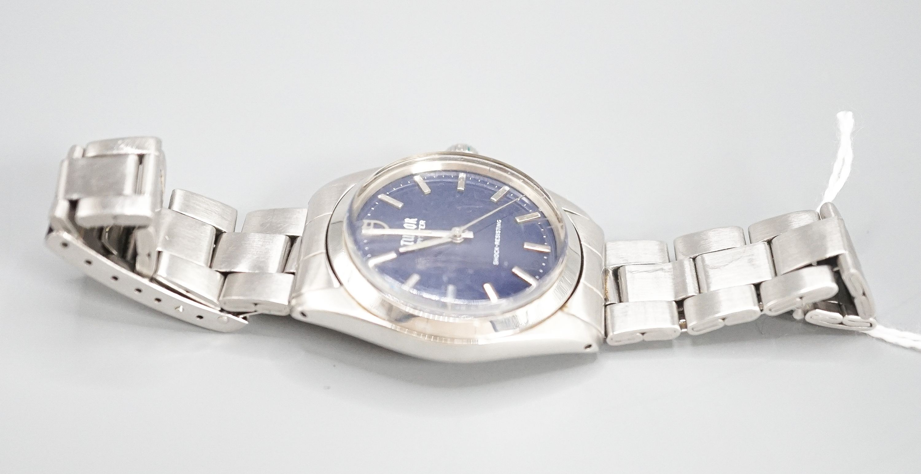 A gentleman's stainless steel Tudor Oyster manual wind wrist watch, with blue dial, on Rolex bracelet, case diameter 34mm, no box or papers.